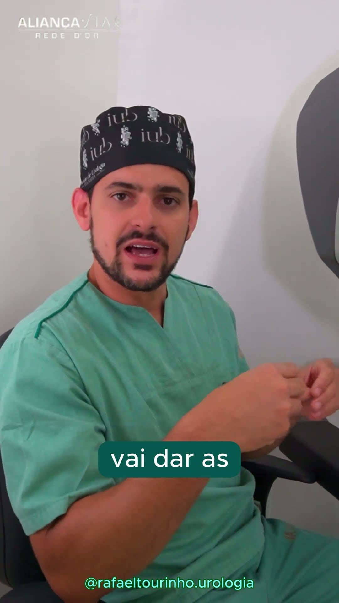 Dr. Rafael Tourinho in surgical scrubs and cap, speaking to camera in a consulting room